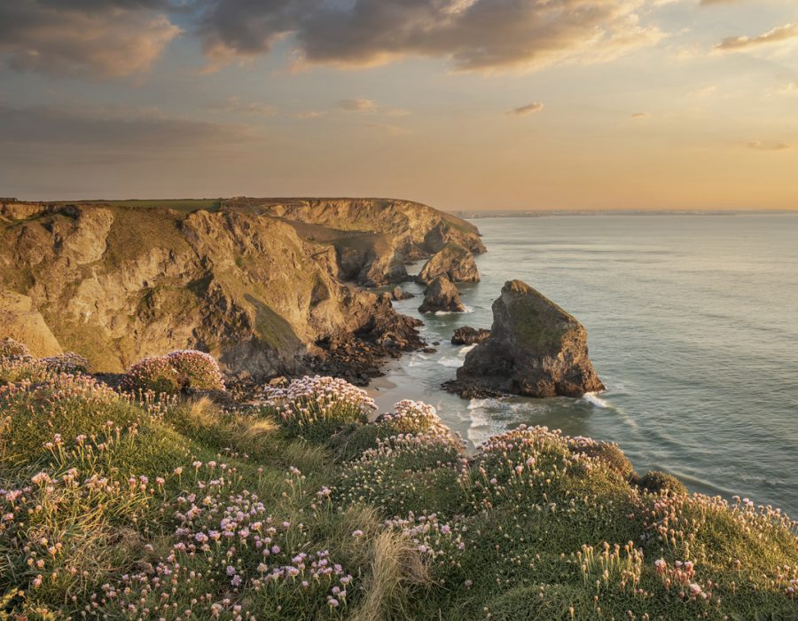 Stunning landscape image during golden hour on Cornwall coastline at Bedruthan Steps